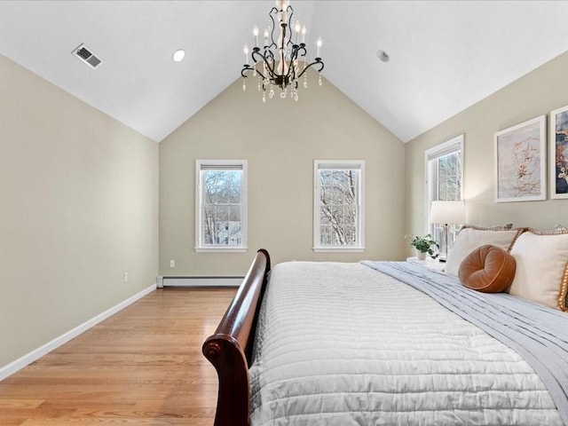 bedroom with lofted ceiling, light hardwood / wood-style flooring, and baseboard heating