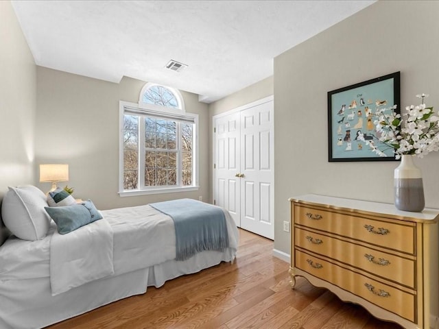 bedroom featuring light hardwood / wood-style flooring and a closet