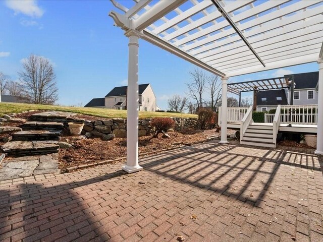 view of patio featuring a deck and a pergola