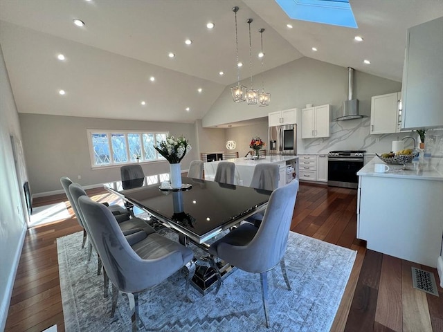 dining room featuring visible vents, recessed lighting, a skylight, high vaulted ceiling, and dark wood-style flooring