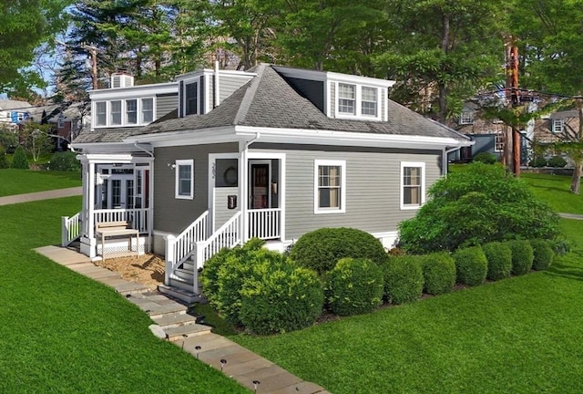 bungalow featuring roof with shingles and a front yard