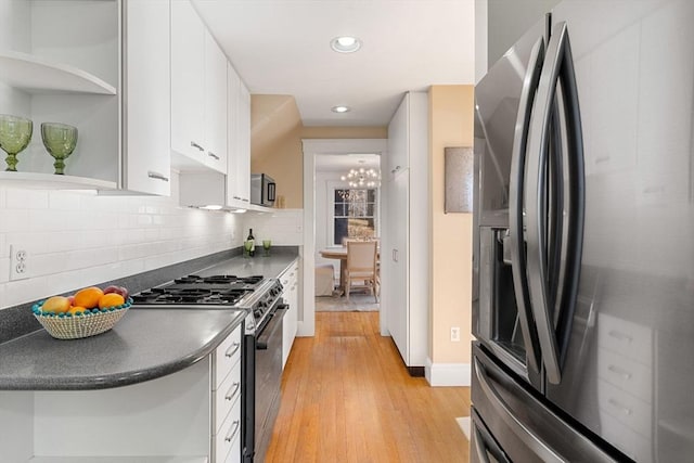 kitchen with black fridge with ice dispenser, white cabinets, light wood-type flooring, open shelves, and gas stove