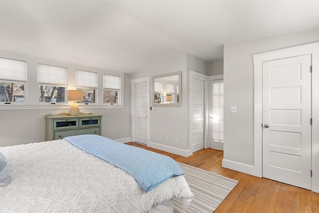 bedroom with baseboards and wood finished floors