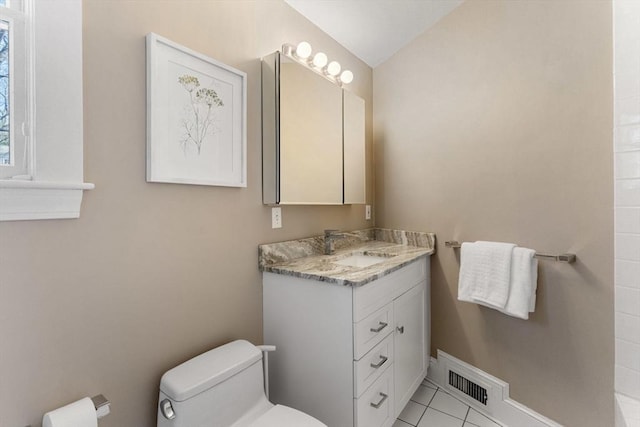 bathroom featuring visible vents, toilet, vaulted ceiling, vanity, and tile patterned floors