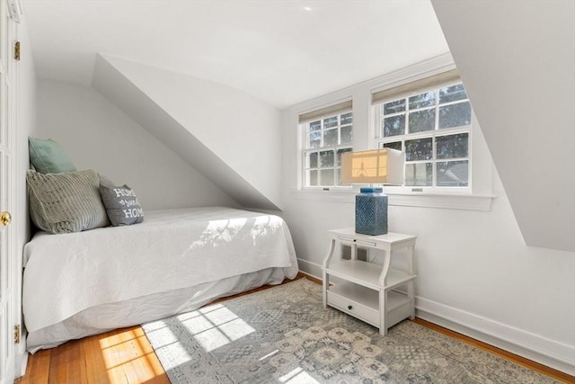 bedroom with baseboards and wood finished floors