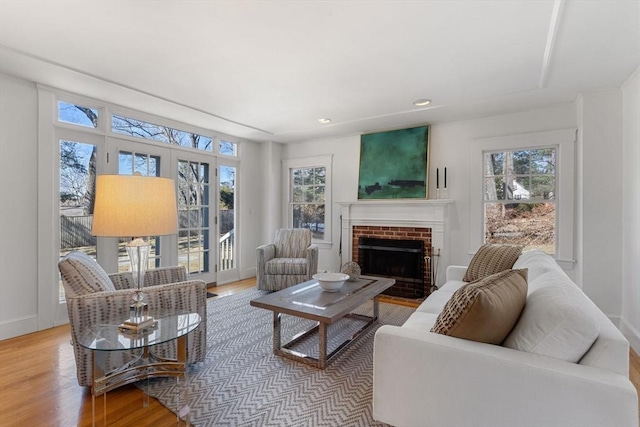 living room with a fireplace, baseboards, wood finished floors, and recessed lighting