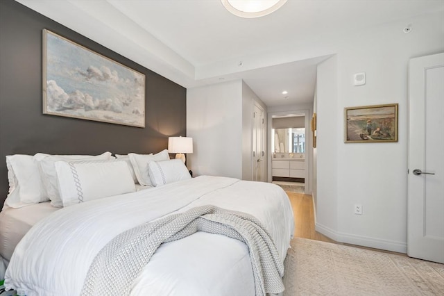 133 Seaport Blvd Unit 823, Boston, MA 02210 - bedroom with light wood finished floors, baseboards, connected bathroom, and recessed lighting