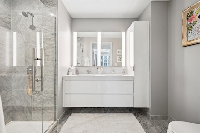133 Seaport Blvd Unit 823, Boston, MA 02210 - bathroom featuring a shower stall, double vanity, toilet, and baseboards