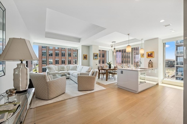 133 Seaport Blvd Unit 823, Boston, MA 02210 - living area featuring light wood-style flooring, a tray ceiling, and recessed lighting