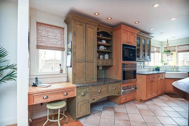 kitchen with oven, black microwave, a sink, recessed lighting, and a warming drawer