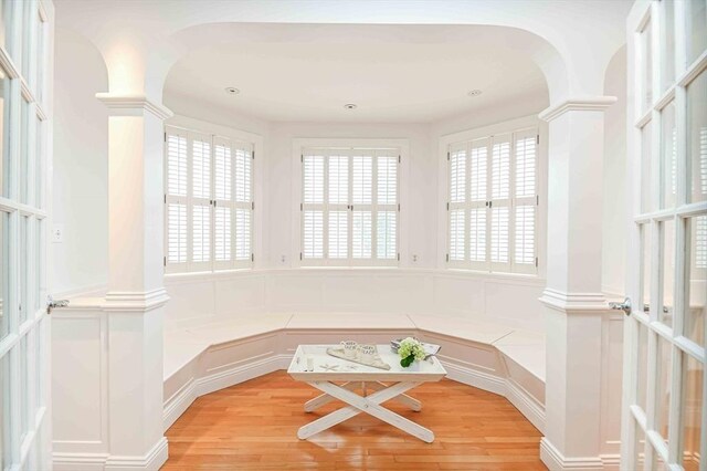 unfurnished sunroom featuring arched walkways