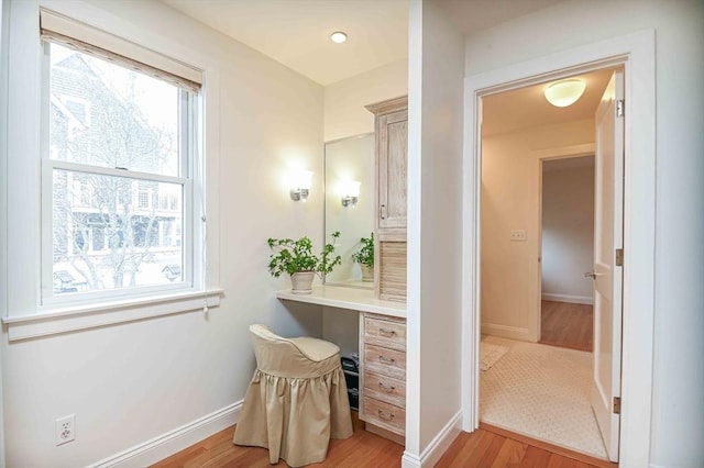 bathroom with baseboards and wood finished floors
