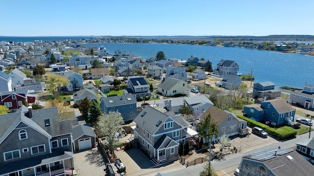 drone / aerial view featuring a residential view and a water view