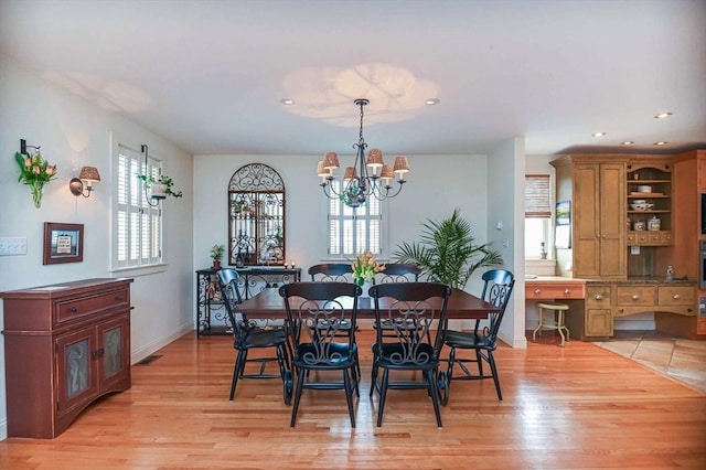 dining area featuring recessed lighting, baseboards, a chandelier, and light wood finished floors
