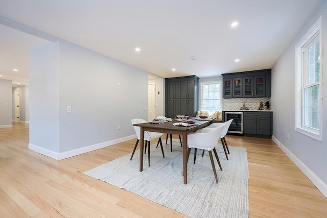 44 Dean Rd, Wayland, MA 01778 - dining space with beverage cooler, light wood-style floors, a bar, baseboards, and recessed lighting