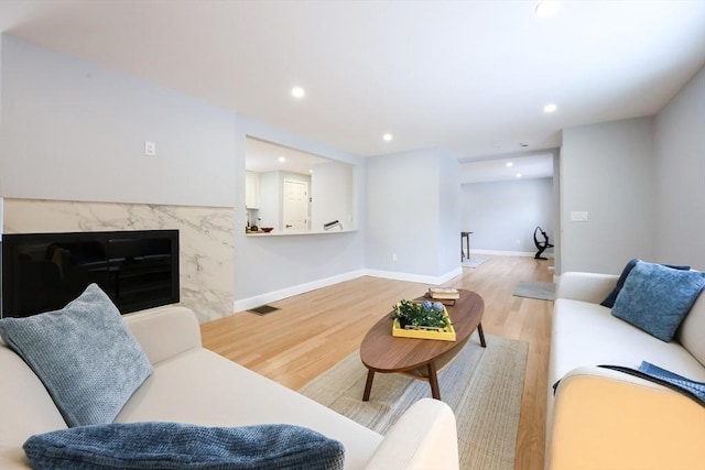44 Dean Rd, Wayland, MA 01778 - living room with light wood-type flooring, recessed lighting, a high end fireplace, and baseboards