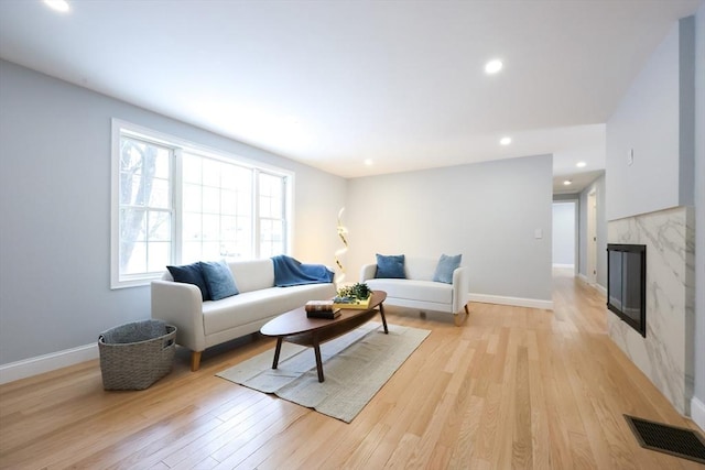 44 Dean Rd, Wayland, MA 01778 - living area featuring light wood-style flooring, baseboards, a high end fireplace, and recessed lighting