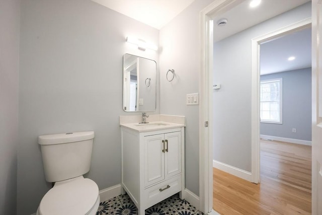 44 Dean Rd, Wayland, MA 01778 - bathroom with toilet, baseboards, vanity, wood finished floors, and recessed lighting