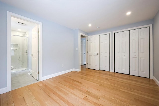 44 Dean Rd, Wayland, MA 01778 - unfurnished bedroom with multiple closets, baseboards, light wood finished floors, and recessed lighting