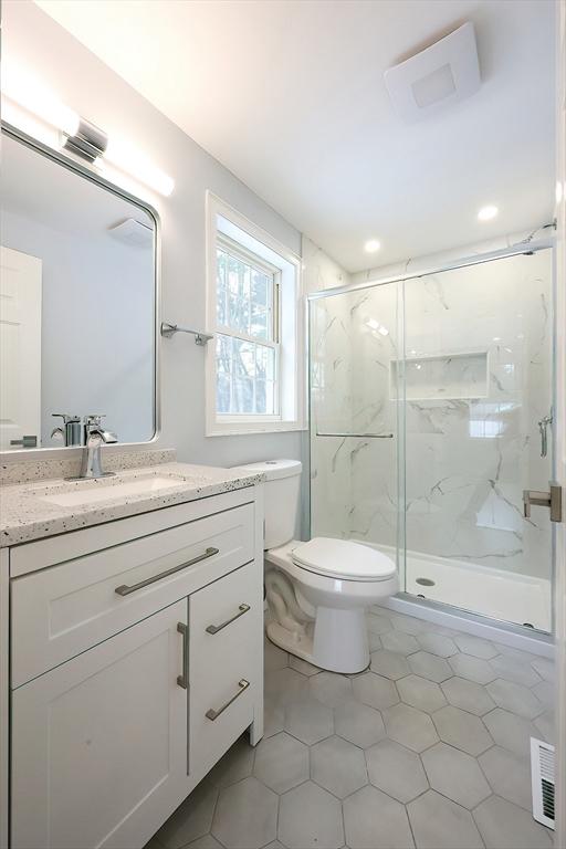 44 Dean Rd, Wayland, MA 01778 - full bathroom featuring toilet, a marble finish shower, vanity, tile patterned flooring, and recessed lighting