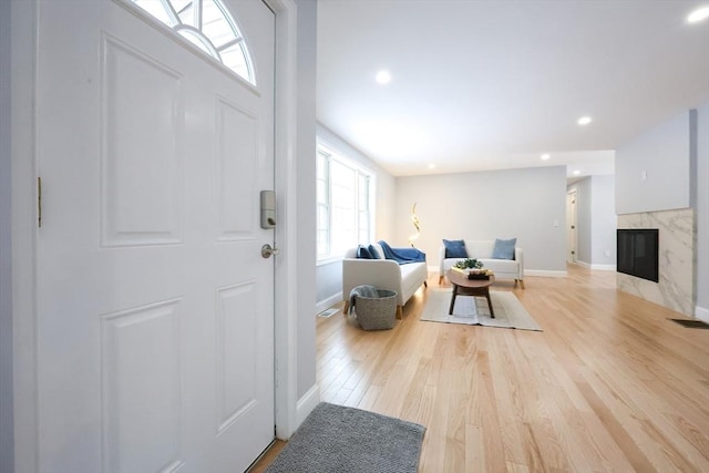 44 Dean Rd, Wayland, MA 01778 - foyer featuring baseboards, light wood finished floors, a high end fireplace, and recessed lighting