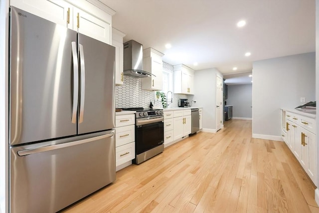 44 Dean Rd, Wayland, MA 01778 - kitchen with appliances with stainless steel finishes, wall chimney range hood, backsplash, light countertops, and light wood finished floors