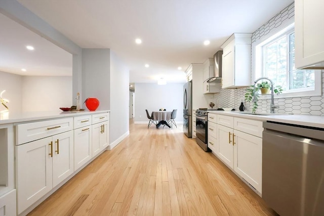 44 Dean Rd, Wayland, MA 01778 - kitchen featuring stainless steel appliances, a sink, light wood-type flooring, tasteful backsplash, and wall chimney range hood
