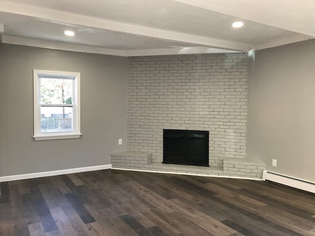 unfurnished living room featuring a baseboard heating unit, hardwood / wood-style floors, crown molding, and a brick fireplace