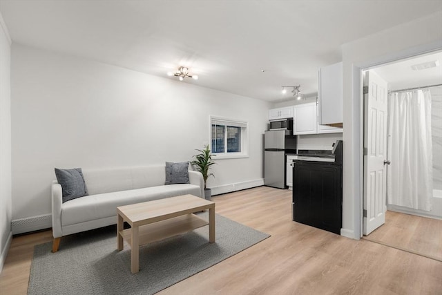 living room featuring light hardwood / wood-style flooring and a baseboard radiator