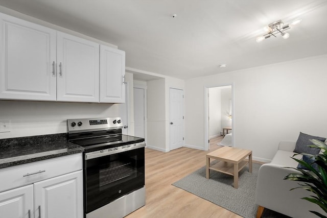 kitchen featuring white cabinets, light hardwood / wood-style floors, and stainless steel range with electric stovetop