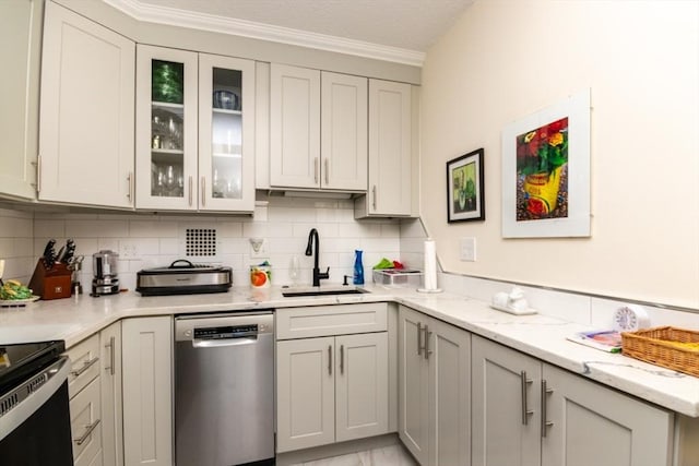 kitchen with dishwasher, a sink, backsplash, glass insert cabinets, and ornamental molding