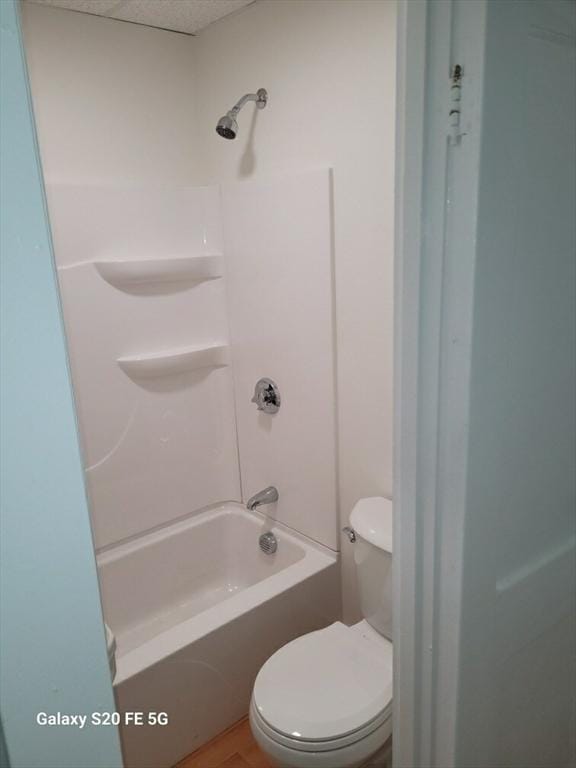 bathroom with washtub / shower combination and toilet