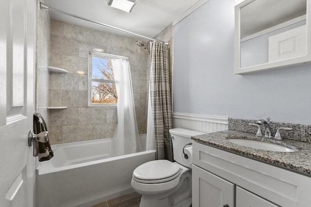 full bathroom with toilet, a wainscoted wall, shower / tub combo with curtain, and vanity