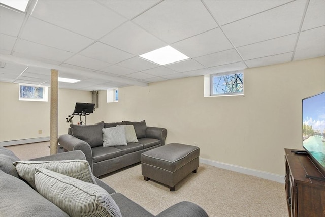 living area featuring carpet, plenty of natural light, baseboard heating, and baseboards