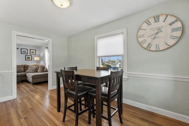 dining area featuring baseboards and wood finished floors