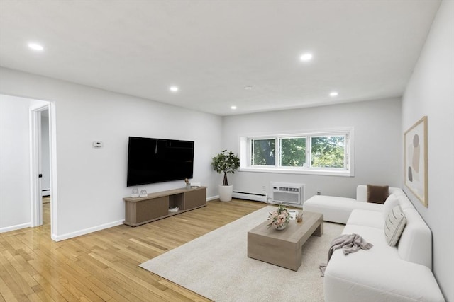 living room featuring a baseboard heating unit, wood finished floors, recessed lighting, and a wall unit AC