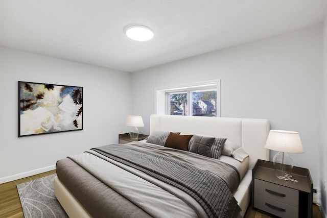 bedroom with wood finished floors and baseboards