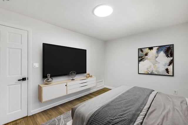 bedroom with wood finished floors and baseboards