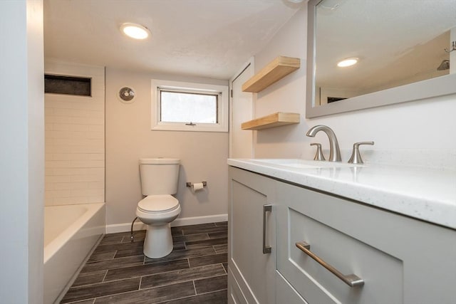 full bathroom with vanity, tiled shower / bath, and toilet