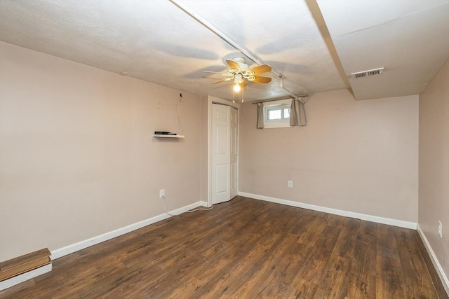 interior space featuring dark wood-type flooring and ceiling fan