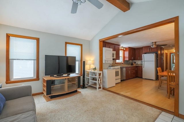 carpeted living room with lofted ceiling with beams, ceiling fan, and sink