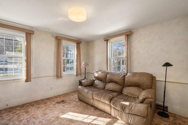 living room featuring carpet floors, plenty of natural light, and baseboards