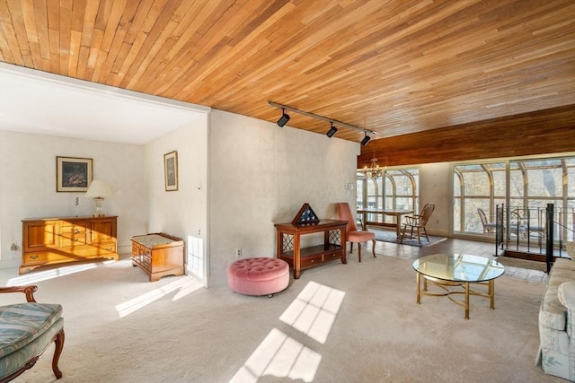 carpeted living room featuring wood ceiling, rail lighting, and an inviting chandelier