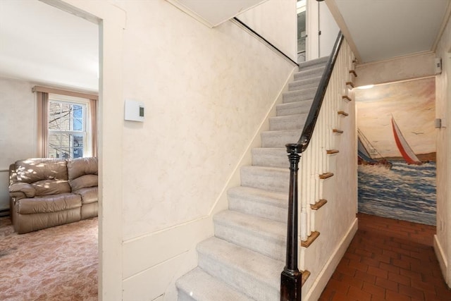 stairway featuring brick floor