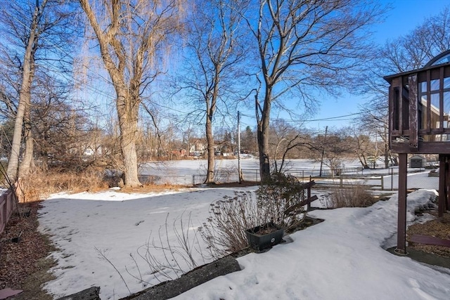 snowy yard with fence