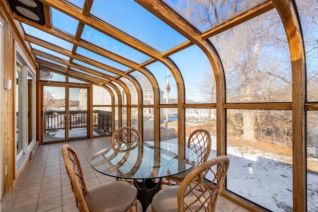 unfurnished sunroom with lofted ceiling