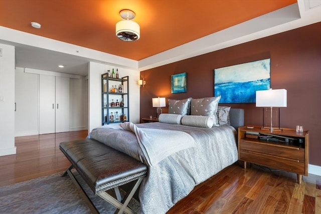 bedroom featuring a closet and dark hardwood / wood-style floors