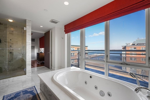 bathroom with a water view and independent shower and bath