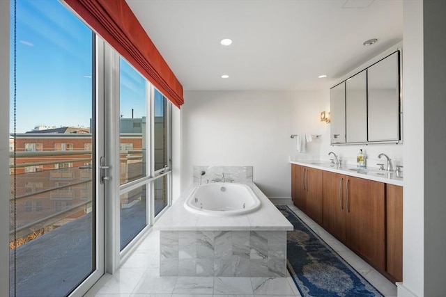 bathroom with vanity and a relaxing tiled tub