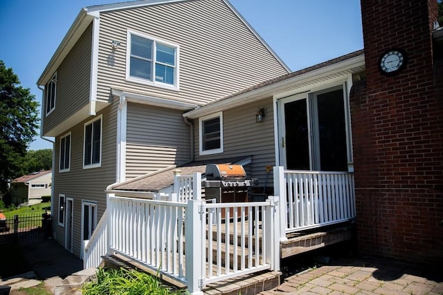 3 Arrowhead Ave, Auburn, MA 01501 - back of property with a wooden deck and a chimney
